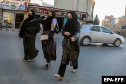 Female students leave Kabul University on December 21, 2022, after the Taliban banned them from attending universities.