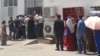 Turkmen line up for subsidized food at a state store. (file photo)