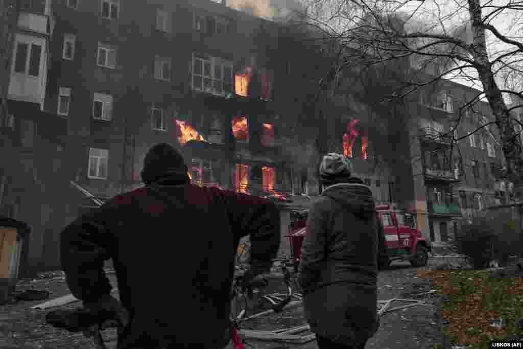 Local residents watch as their apartment burns following shelling on December 7.&nbsp; Before Russia&#39;s invasion, the city had a population of 70,000 and was known mostly for its large salt mine and vineyards.