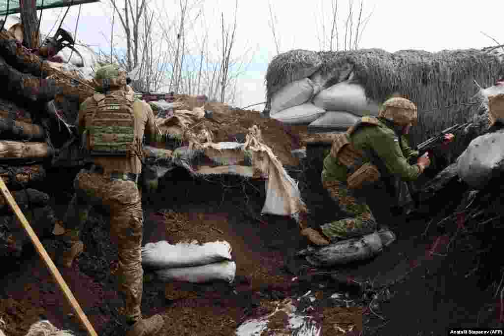 Ukrainian soldiers take positions in trenches in the Luhansk region on April 11.&nbsp;