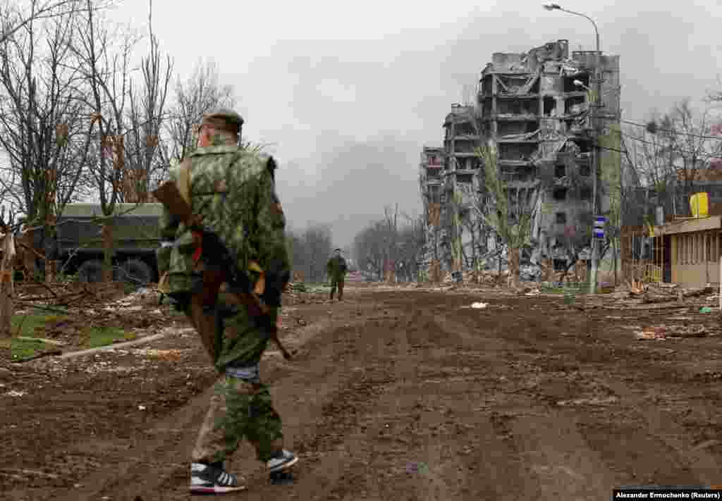 Separatist troops pass the Azovstal plant on April 12.&nbsp;