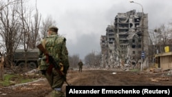 Pro-Russia troops patrol a street near the Azovstal Iron and Steel Works plant in the Ukrainian port city of Mariupol on April 12. 