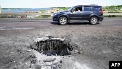 The Antonivsky Bridge across the Dnieper River near the Russian-held city of Kherson has been badly damaged by Ukrainian strikes.