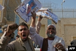 Afghan demonstrate against the alleged published reports of harassment of Afghan refugees in Iran, outside of the Iranian consulate in Herat, Afghanistan, on April 11, 2022.