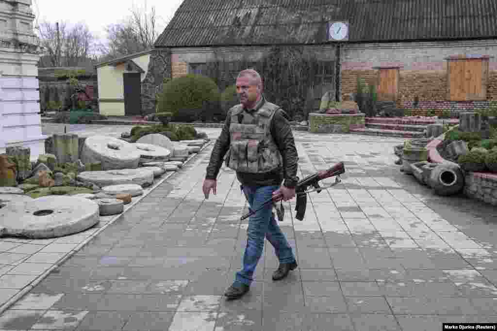 Balo Oleksandr, the mayor of the Ukrainian-held town of Barvinkove, is pictured carrying a weapon on April 12.&nbsp;