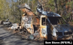 Gutted vehicles along a road into Lyman on October 9.