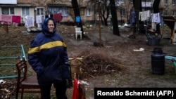 An elderly woman cries near her house in Bucha, northwest of Kyiv, on April 2. The town's mayor said 280 people had been buried in a mass grave and that the town was littered with corpses.