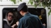 An officer from Iran's morality police speaks with a woman about her hijab in Tehran. (file photo)