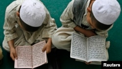 Young boys study at a madrasah in Afghanistan.
