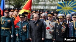 Russian President Vladimir Putin (center) attends a wreath-laying ceremony at the Tomb of the Unknown Soldier on Victory Day in central Moscow on May 9.