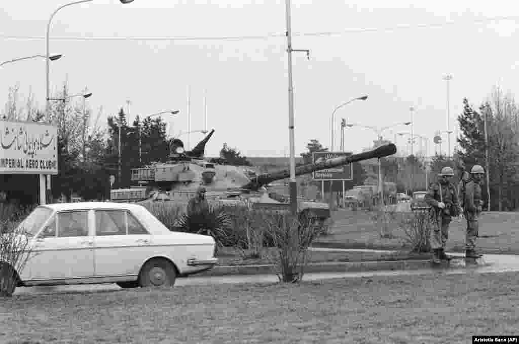 An Iranian army tank and soldiers on a road leading to Tehran&#39;s airport. The army prevented an Iranian Airlines jet from taking off for Paris to pick up exiled Islamic leader Ayatollah Khomeini for his return to Iran.