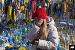 A woman cries at the memorial to the fallen Ukrainian soldiers on Independence Square in Kyiv, Ukraine