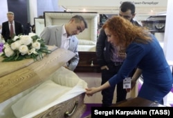 Visitors inspect the lining of a coffin during the unusual trade fair.