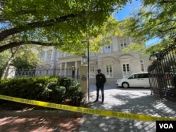 FBI officers are seen outside the home of Russian oligarch Oleg Deripaska in Washington in October 2021.