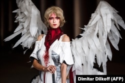 A woman models a dress during a funeral fashion show of "mourning dresses."