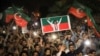 Supporters of Imran Khan's Tehrik-e Insaf (PTI) party wave flags and chant in support of the former prime minister at a rally in Peshawar on April 10.