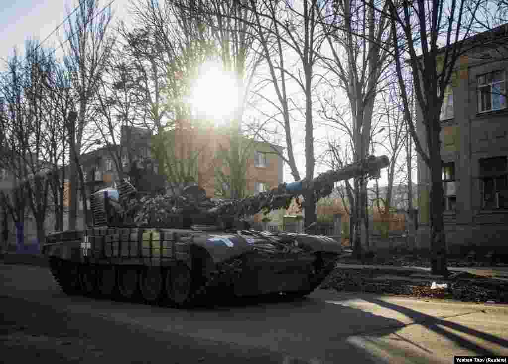 Ukrainian soldiers ride atop a tank on December 5. Russian forces have been pounding the city as Ukrainian forces try to solidify their gains farther to the north as fighting switched from the south to the eastern Donbas region.