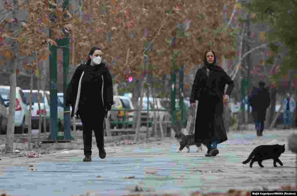 Two women, one of whom has removed her head scarf, walk in Tehran on December 6.&nbsp; In 1983, Iran&#39;s Islamist government decreed that &quot;women who appear in public without religious hijab will be sentenced to a whipping of up to 74 lashes,&quot; though short terms of imprisonment were a more common punishment.&nbsp;