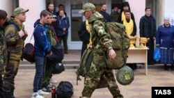 Mobilized men are seen at a gathering station set up in a cultural center in the town of Bataisk in southwestern Russia.