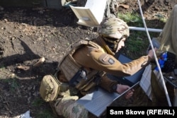 Kim works with a loaded laptop to reboot a drone.