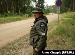 Estonian border guard Viktor Kullasaar monitors traffic through the meters-long stretch of Russian territory.