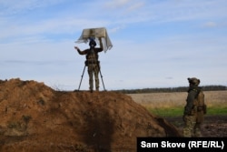 A Ukrainian drone operator known as "Kim" sets up an antenna for controlling a drone in the Kharkiv region on October 22.