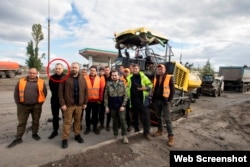 Yuriy Holyk accompanies Kyrylo Tymoshenko, the deputy head of President Zelenskiy’s office, on a July 2022 trip to review reconstruction in the city of Izyum after the withdrawal of Russian troops.