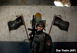 A commando of the Afghan National Army undergoes training by U.S. forces near Kabul in 2011.