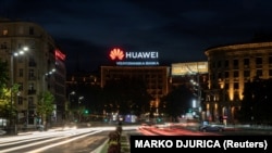 Cars drive past a Huawei logo on a building in central Belgrade, Serbia (file photo).