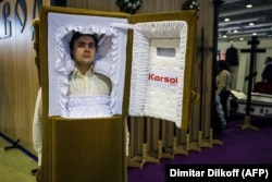 A man dressed as a coffin at the trade fair.