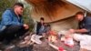 Afghans prepare food at an improvised camp in northern Bosnia in October 2021.