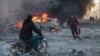 People try to extinguish fires following an air strike that targeted Syria's rebel-held northern city of Idlib on December 2. Since Russia intervened in the civil war in Syria, its aerial attacks have played a crucial role in propping up Syrian President Bashar al-Assad.