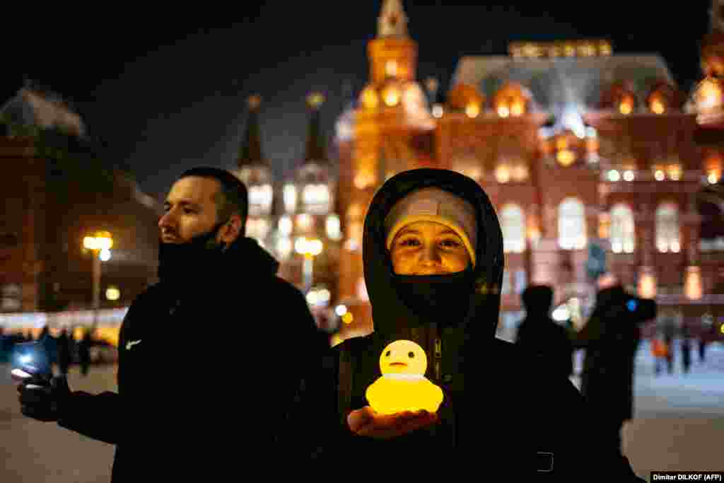 A woman poses with a glowing plastic duck near Red Square in Moscow on February 14. The duck is a reference to allegations that former Prime Minister (and one-term President) Dmitry Medvedev has a luxury property with a private lake and a shelter for waterfowl.