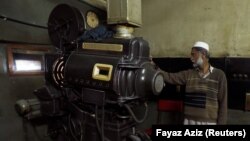 A man operates a projector at a cinema house in Peshawar, Pakistan.