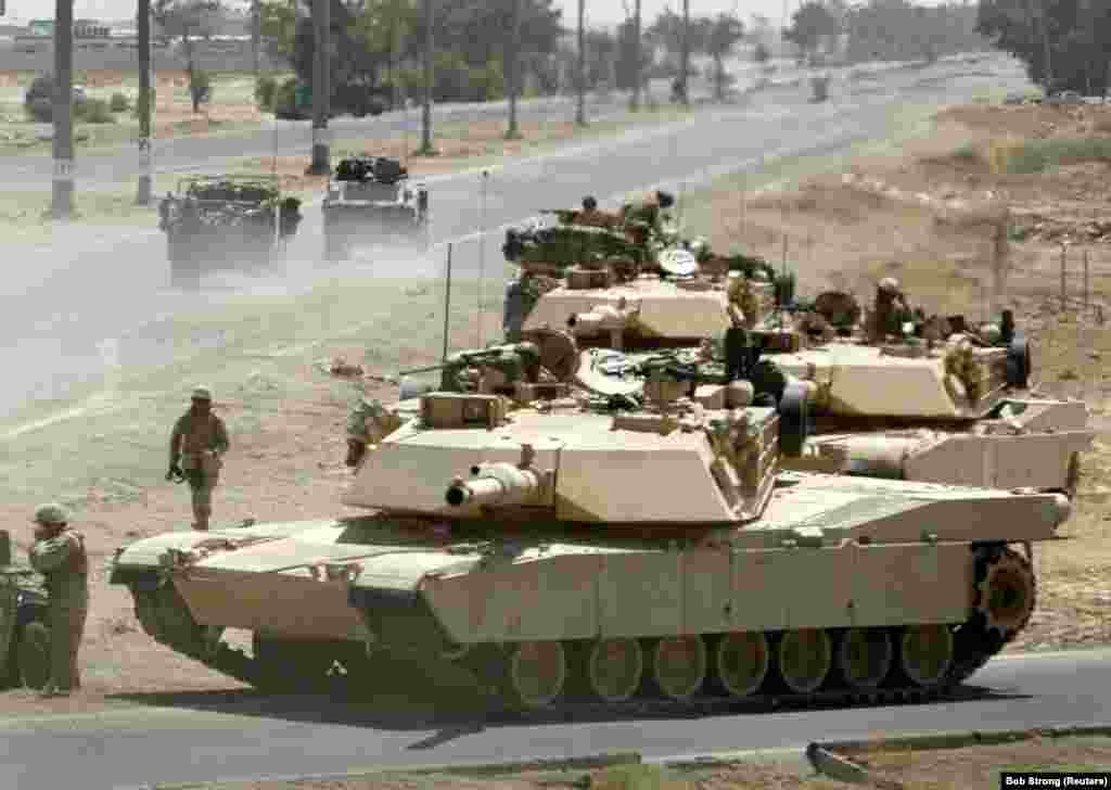 U.S. Marine Corps M1A1 Abrams tanks take up defensive positions during a firefight near the main traffic checkpoint in Fallujah, Iraq, on June 24, 2004. The export version of the Abrams is used by the armies of Australia, Egypt, Iraq, Kuwait, Poland, and Saudi Arabia.&nbsp;