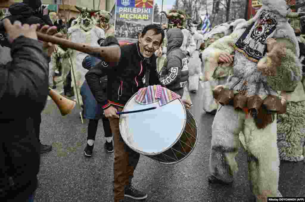 As a man bangs a drum, dancers wearing bells sway like a wheat spike heavy with grain&nbsp;to drive away sickness and evil spirits.