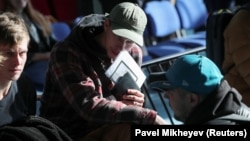 Russian citizens wait in a Kazakh public service center to receive an individual identification number for foreigners in the city of Almaty in October 2022.