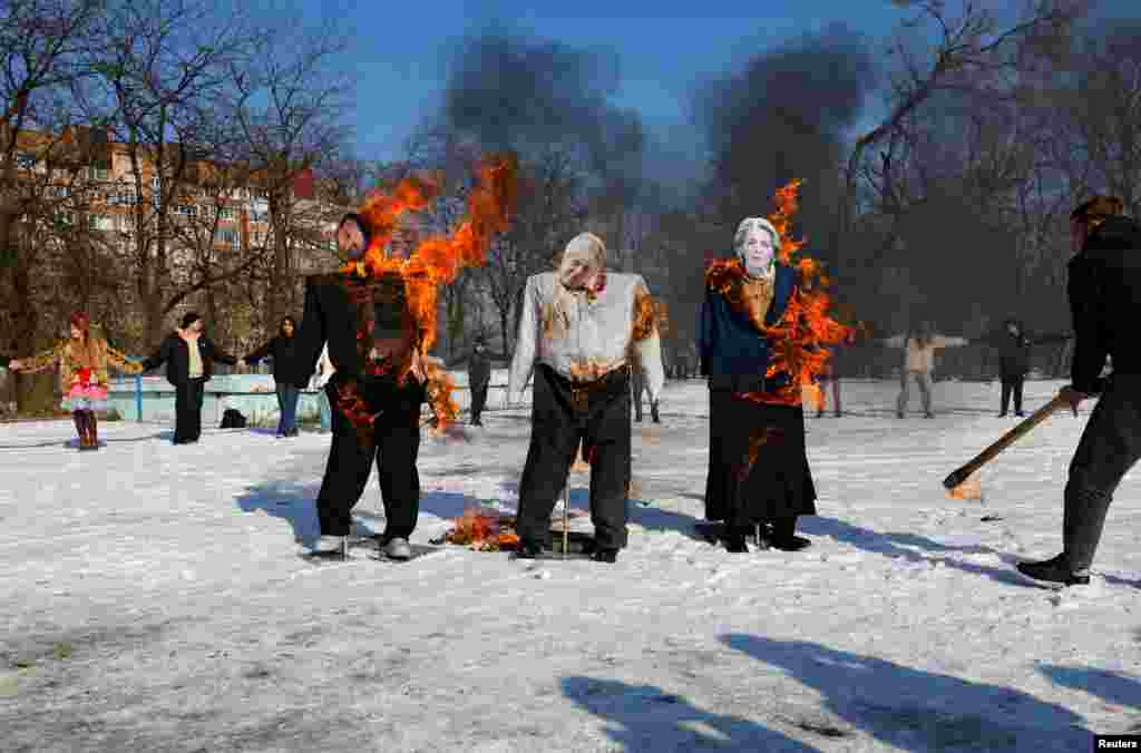 In Ukraine's Russian occupied Donetsk region, effigies depicting French President Emmanuel Macron, British ex-Prime Minister Boris Johnson, and European Commission President Ursula von der Leyen are burned during celebrations of the Maslenitsa pagan holiday marking the end of the winter.