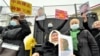 People demonstrate outside the Chinese Consulate in Almaty, demanding the release of relatives in China's Xinjiang region, in February 2021.