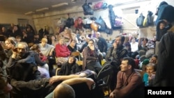 One of the few photos from inside the basement during captivity taken by an individual who managed to hide his phone shows dozens of people crowded in a room shoulder-to-shoulder.