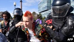 Riot police detain a protester in Moscow. State media have sought to portray the demonstrators as radicals or misfits.