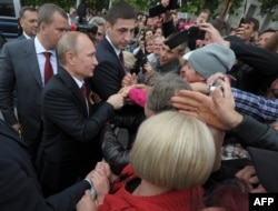 Russian President Vladimir Putin meets local residents during a visit to the Crimean port of Sevastopol on May 9, 2014.