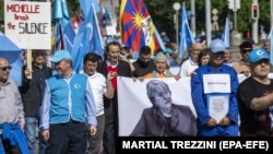 Demonstrators march on May 13 in Geneva outside UN headquarters over what they say is a lack of attention to the persecution of Uyghurs and other groups in China by UN High Commissioner for Human Rights Michelle Bachelet. 