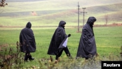 Police officers walk near the site of an explosion in Przewodow, a village in eastern Poland near the border with Ukraine, on November 16. 