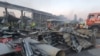 Rescuers working sift through rubble at the Amstor shopping center in Kremenchuk after it was hit by a Russian missile strike on June 27, 2022.