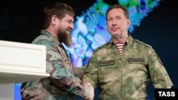 Chechnya leader Ramzan Kadyrov (left) and Viktor Zolotov, the head of Russia's National Guard, shake hands during a ceremony in Grozny to award decorations to military personnel and National Guard officers participating in the war in Ukraine.