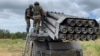 A Russian crew prepares rockets for a "Hurricane" multiple-launch rocket system.