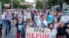 People hold posters saying "We trust Sergei Furgal" during a protest in support of the forner governor in Khabarovsk on July 21.