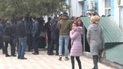 Uzbek students wait to receive their documents in Dushanbe on February 11.