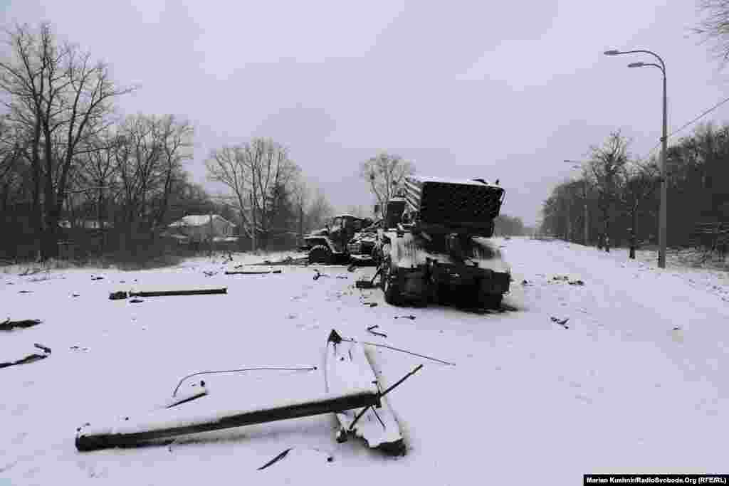 The burned-out hulk of a Russian Grad missile launcher and the body of a soldier near Kharkiv on February 25.